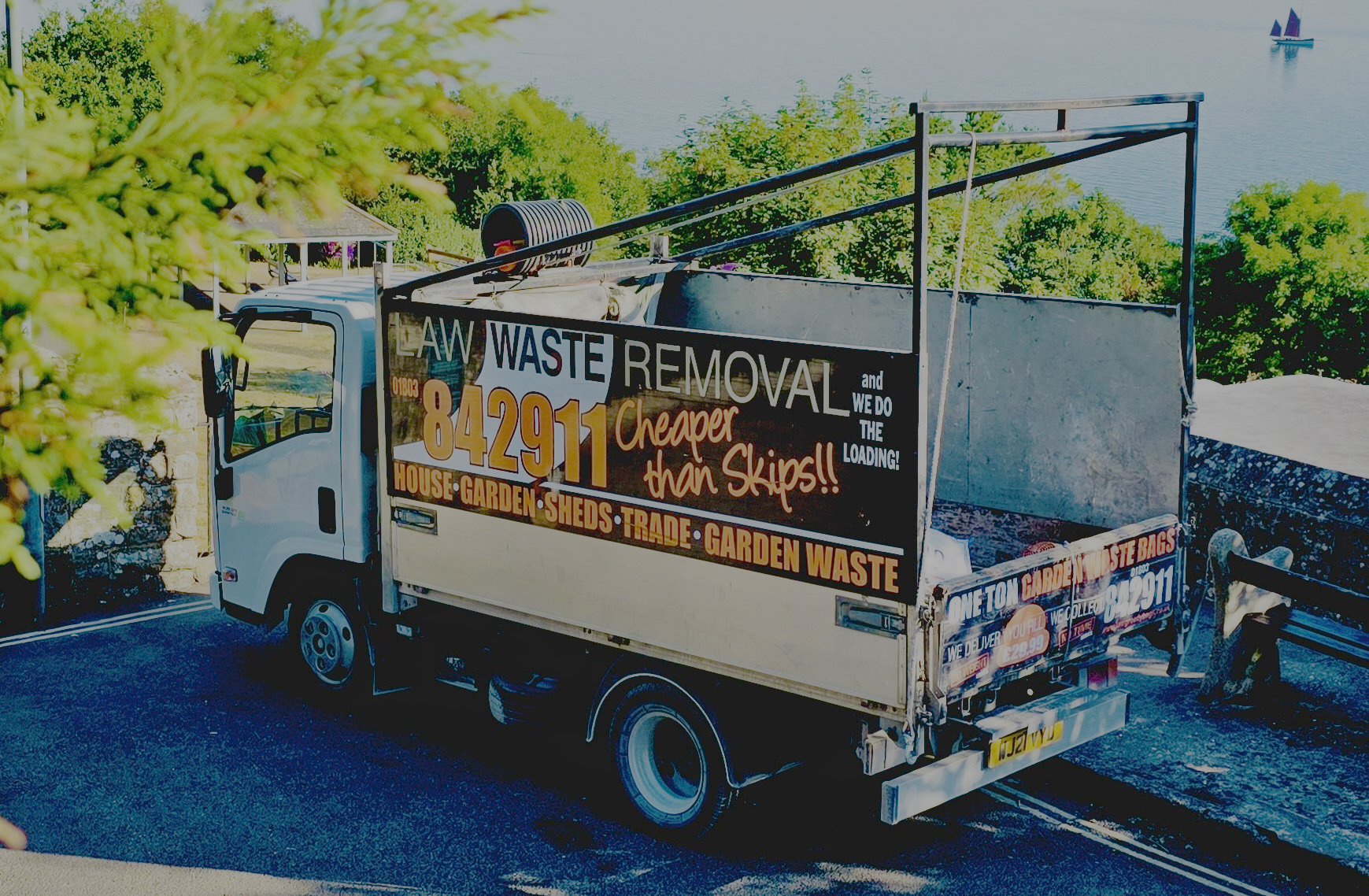 Law Waste Removal tipper truck parked overlooking the sea in Torbay, South Devon